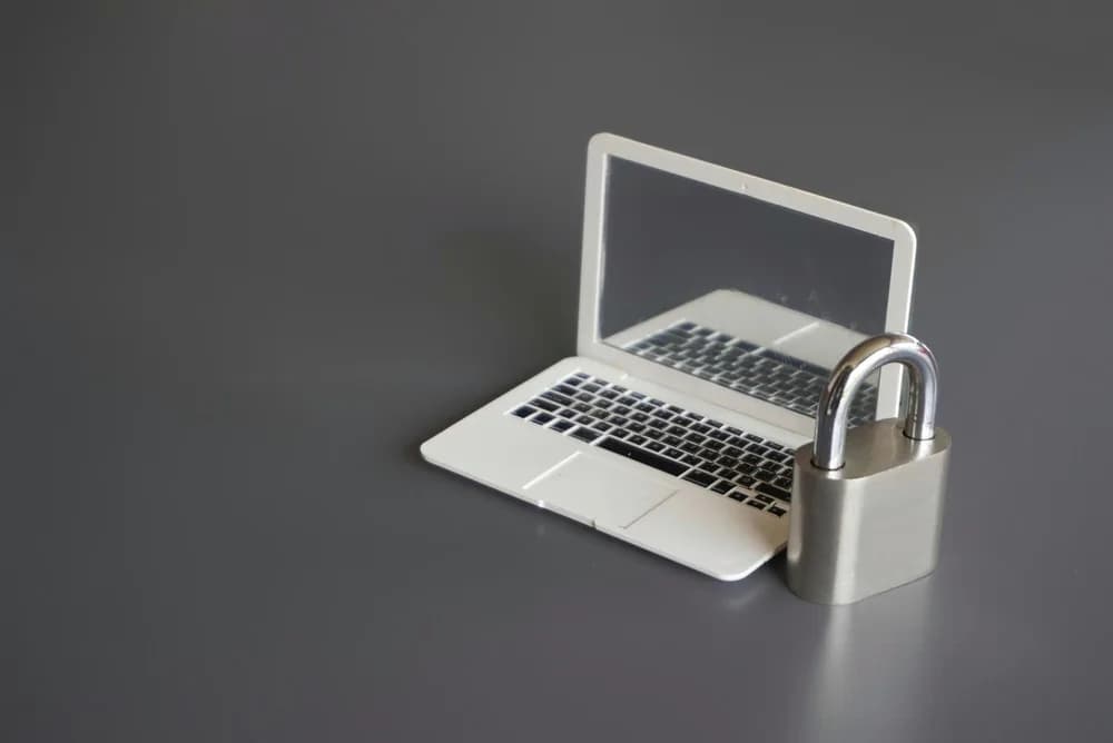 Zámek vedle notebooku znázorňuje zabezpečení digitálních dat.